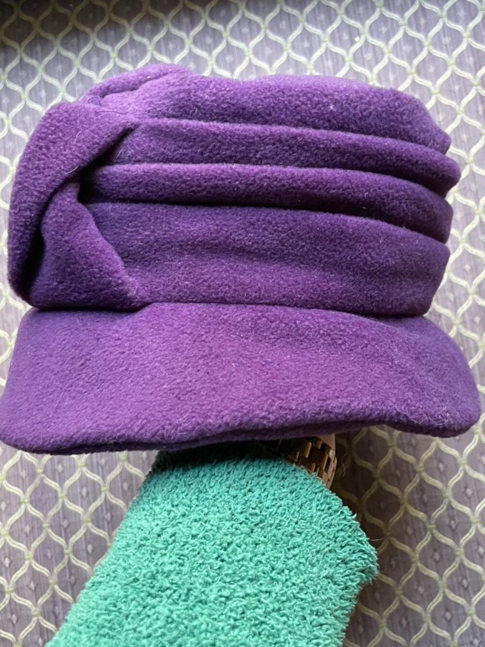 Purple winter hat with a little bow detail.
